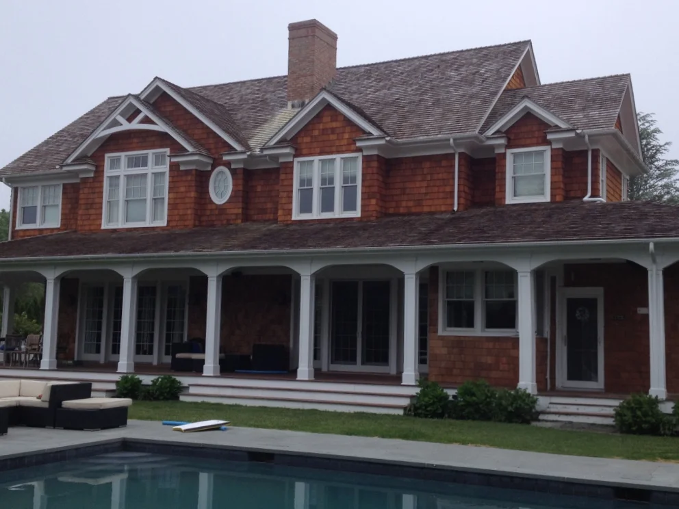 A house with a pool in front of it