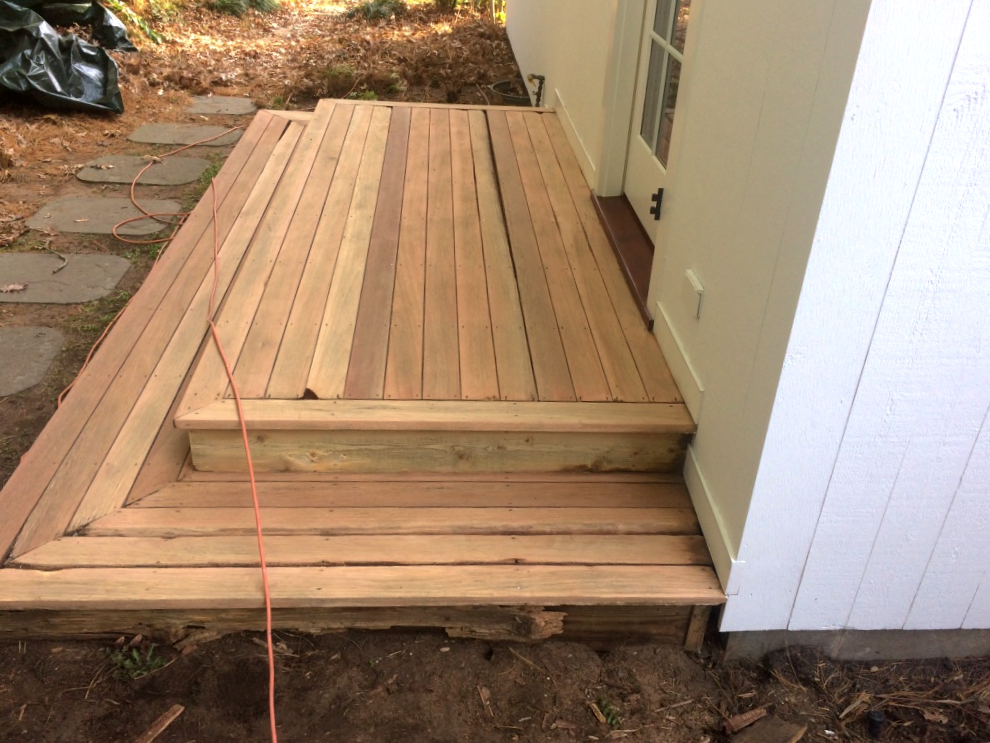 A close up of a wooden deck near a door