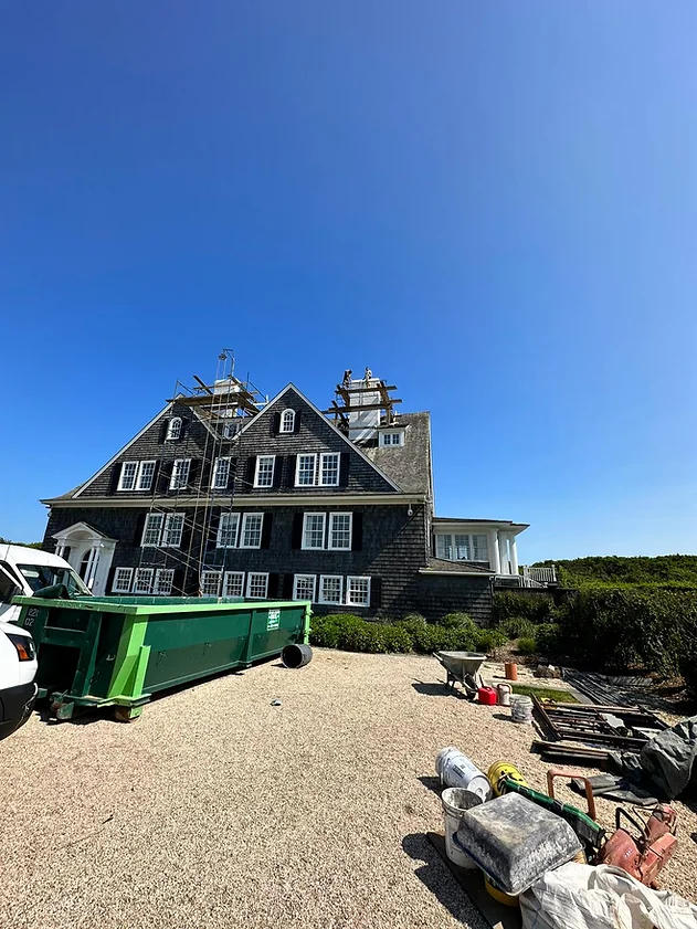 A large house sitting on top of a sandy beach