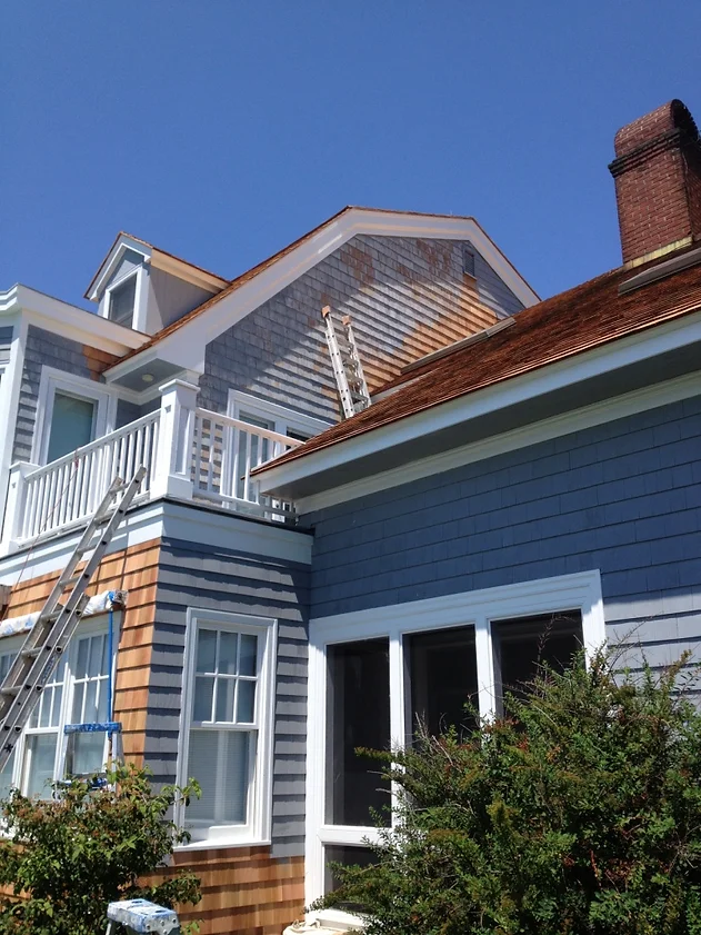 A house that has a ladder on the roof