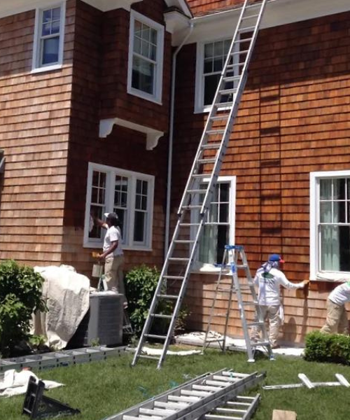 A couple of men working on a house